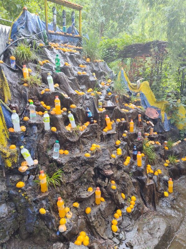 A strange bottle and waterfall stand while hiking up the waterfalls